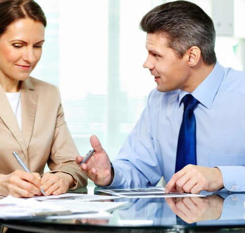 Business partner explaining new strategy to elegant business woman