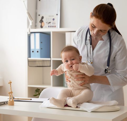 front-view-doctor-holding-cute-baby